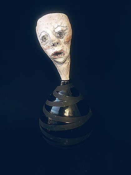 Head sculpture emerging from a ceramic pot